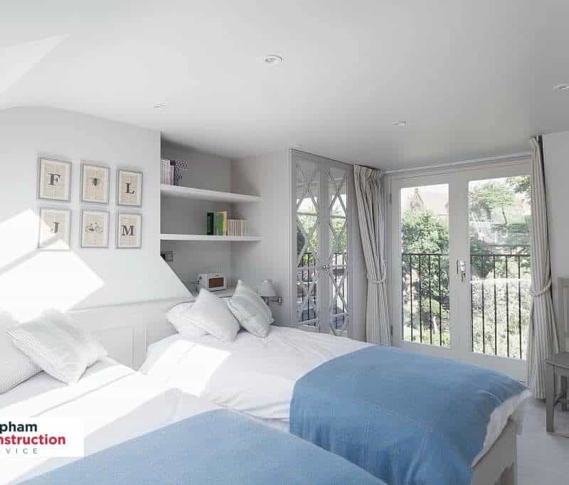 twin bedroom loft conversion blue blankets
