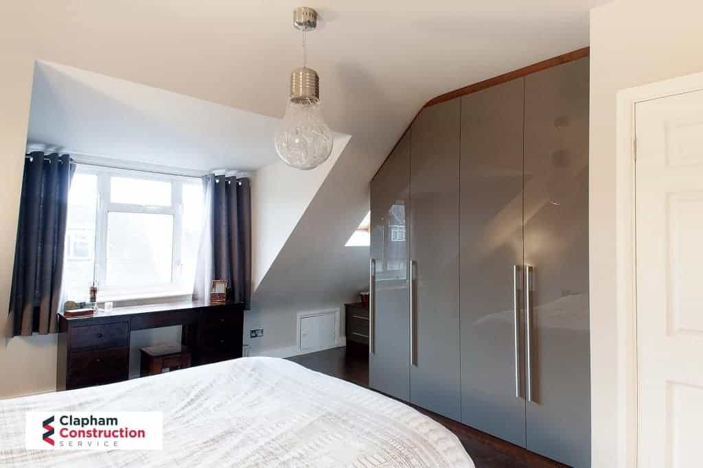 completed guest bedroom loft extension with grey fitted wardrobes