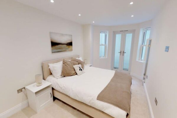 majorie-grove-loft-conversion-bedroom- completed loft conversion with opening doors